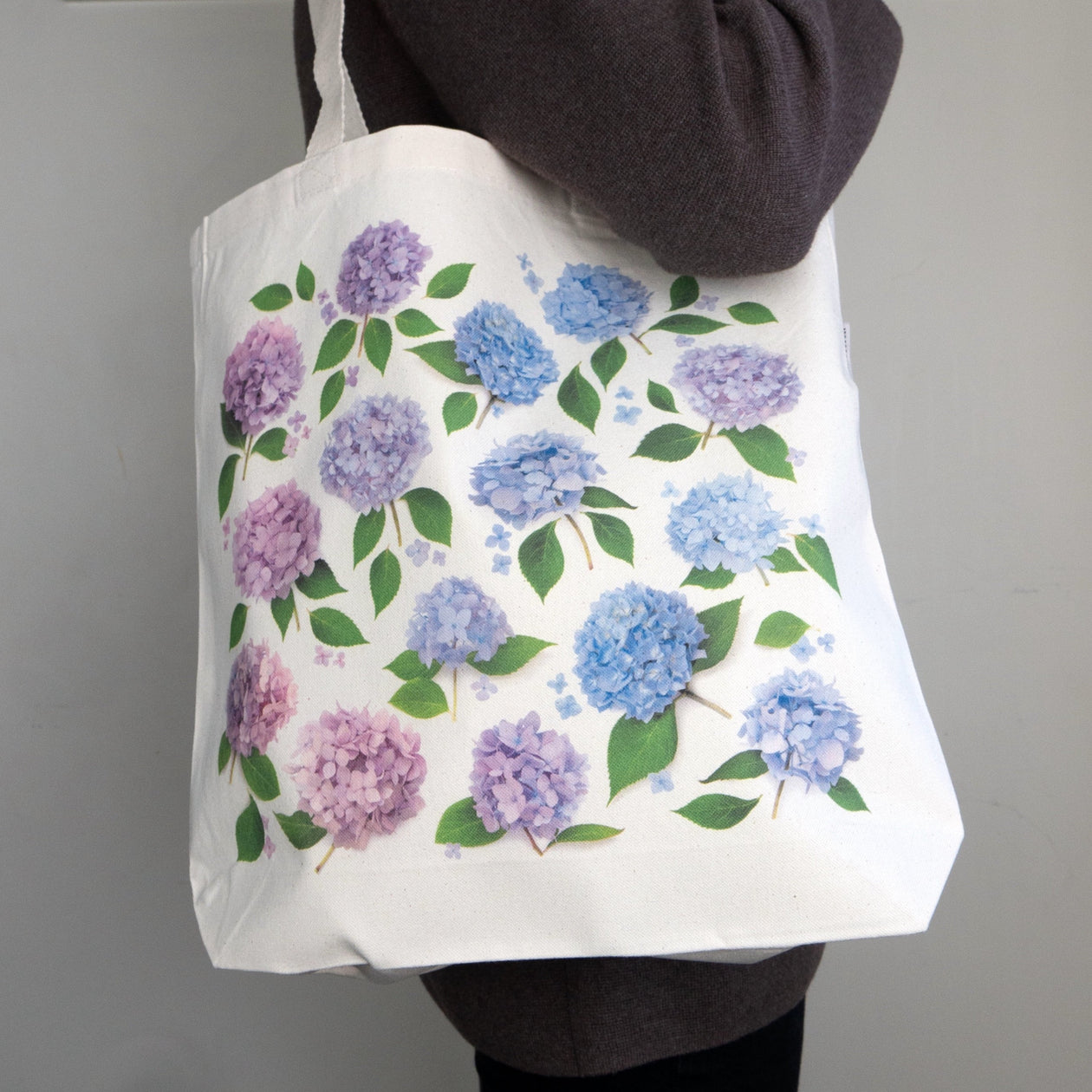 tote bag with hydrangea pattern in pinks, blues, and purples